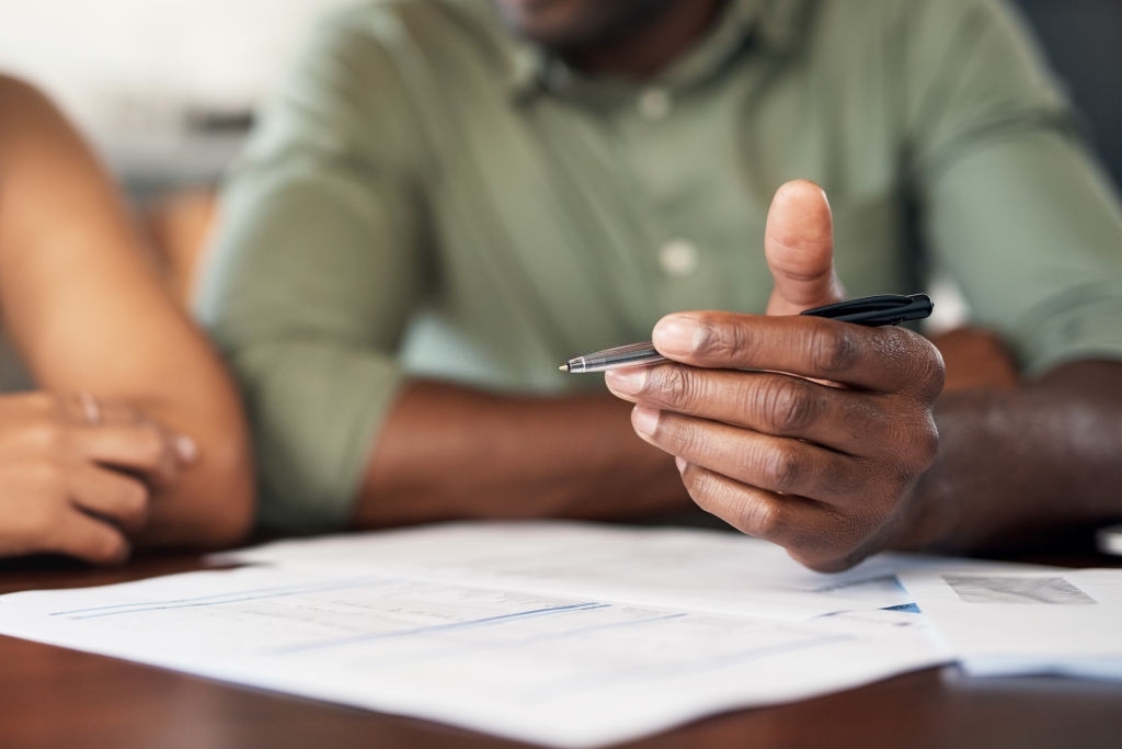 Cropped shot of a couple going through paperwork at home
